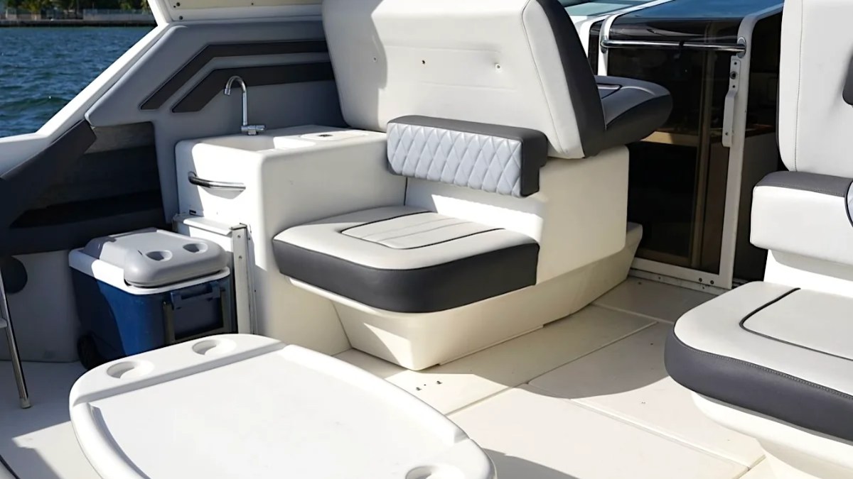 Interior of a boat with white and gray seating.