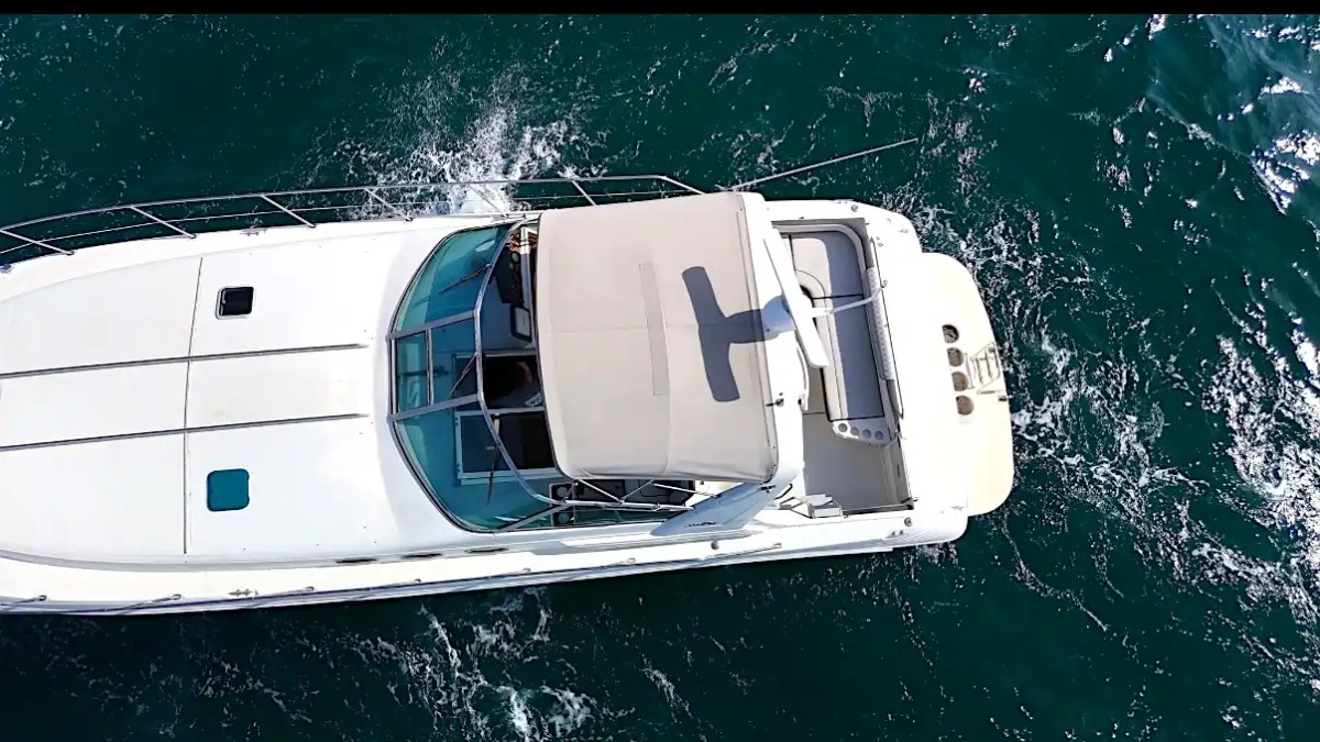 Aerial view of white yacht on blue ocean water.
