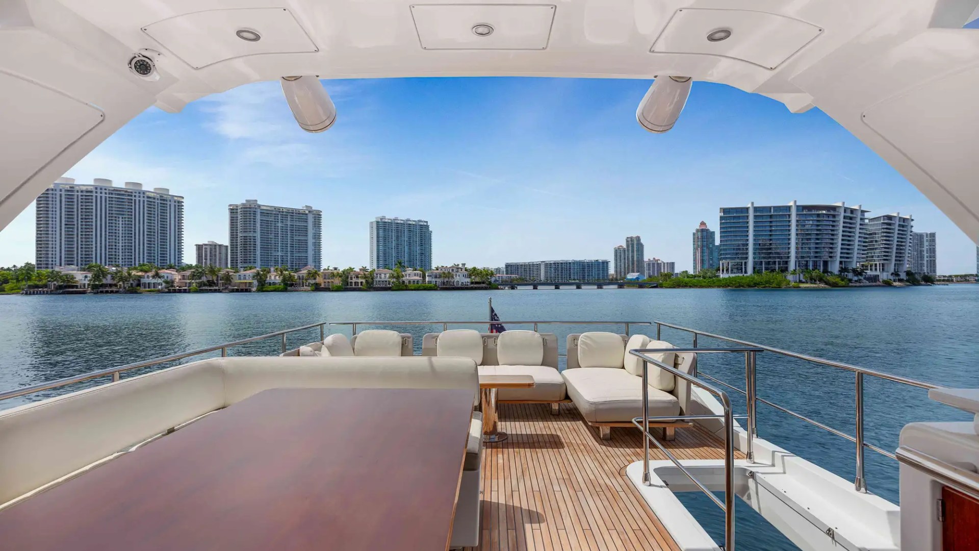 View from yacht deck with city skyscrapers and water.