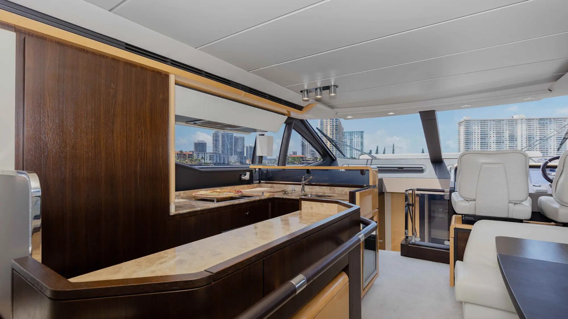 Luxury yacht interior with a bar and city view.