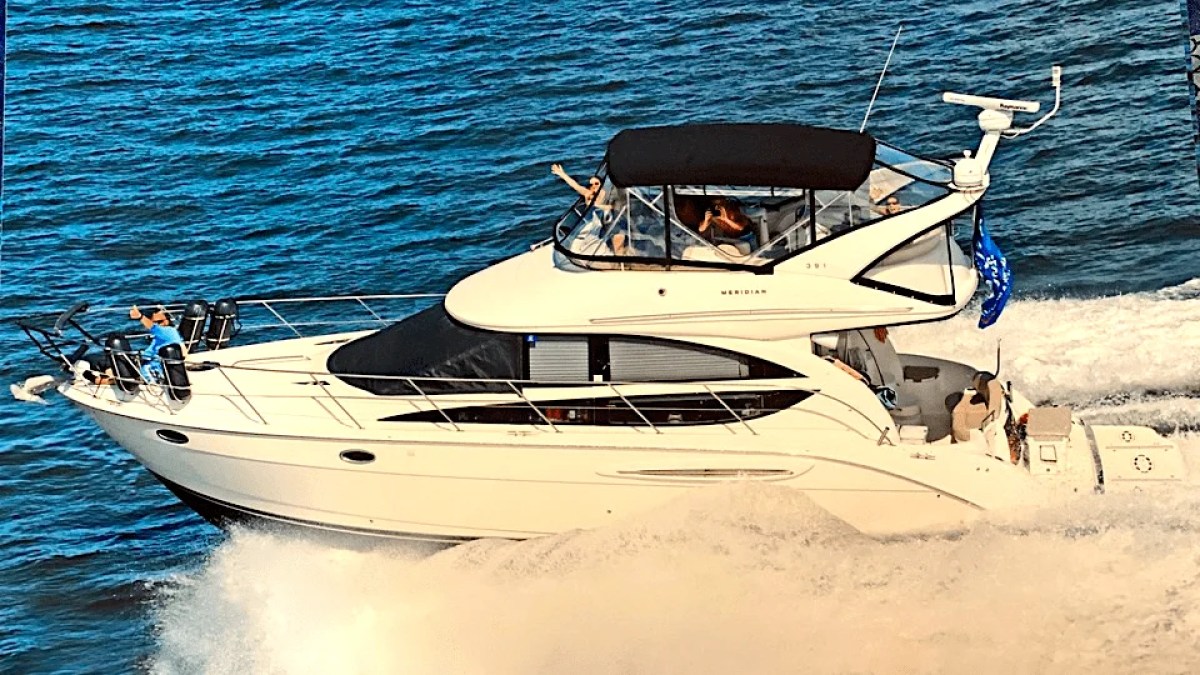 This 44 foot Meridian Boat Rental cruises through Southwest Florida waters with guests relaxing aboard the flybridge and bow while ocean spray and open Gulf of America views surround the vessel.
