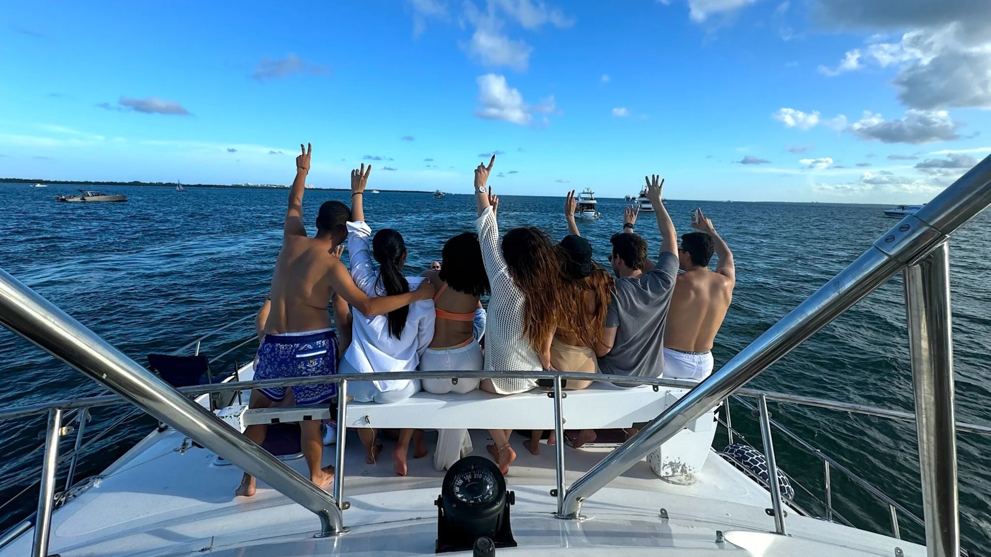 Guests enjoy the bow seating area aboard a 50 foot AfriCat Yacht Charter while cruising Fort Myers waterways, with open Gulf of America views and Southwest Florida coastal scenery stretching across the horizon.