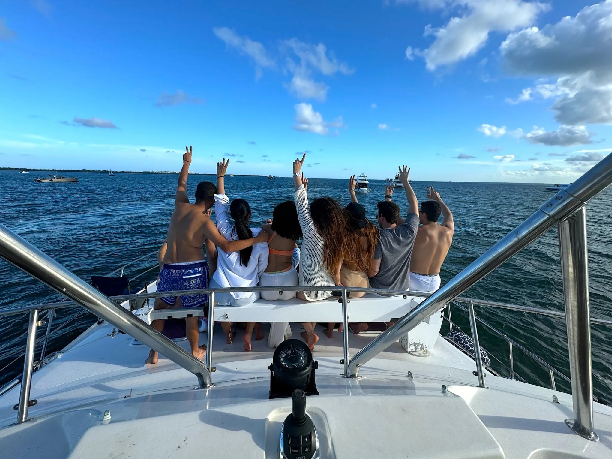 Guests enjoy the bow seating area aboard a 50 foot AfriCat Yacht Charter while cruising Fort Myers waterways, with open Gulf of America views and Southwest Florida coastal scenery stretching across the horizon.