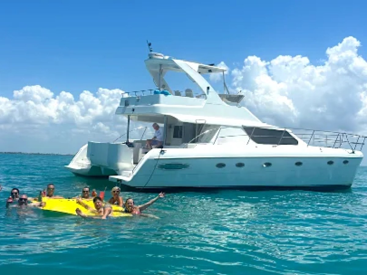This 50 foot AfriCat Yacht Charter is anchored in crystal-clear Gulf of America waters while guests enjoy floating water activities and swimming near Fort Myers, Sanibel Island, and Captiva Island.
