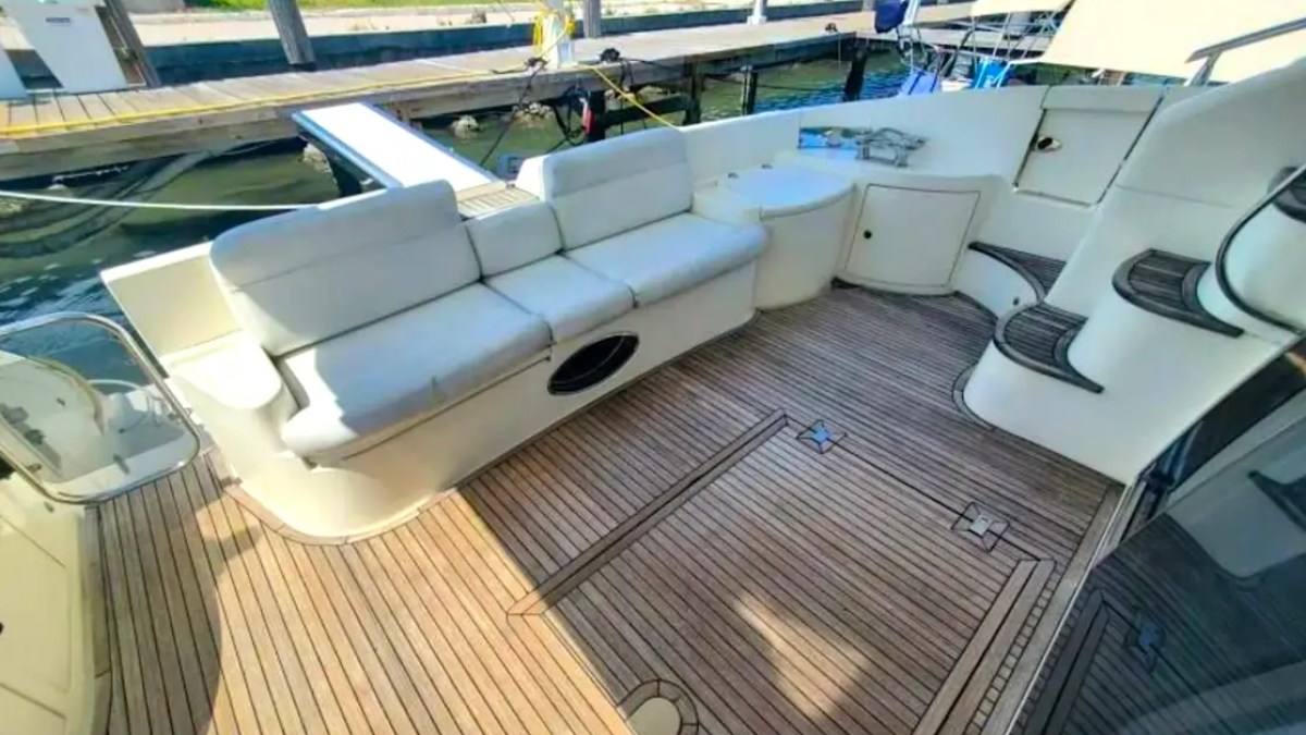 57' Azimut Yacht Charter aft cockpit featuring cushioned lounge seating, teak decking, swim platform access, and an inviting outdoor relaxation space at the Miami marina.
