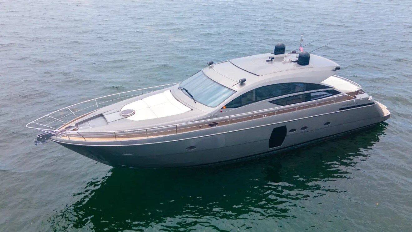 64' Pershing Yacht Charter captured from above showcasing its sleek Italian sport yacht design cruising the crystal-clear waters of Biscayne Bay in Miami.