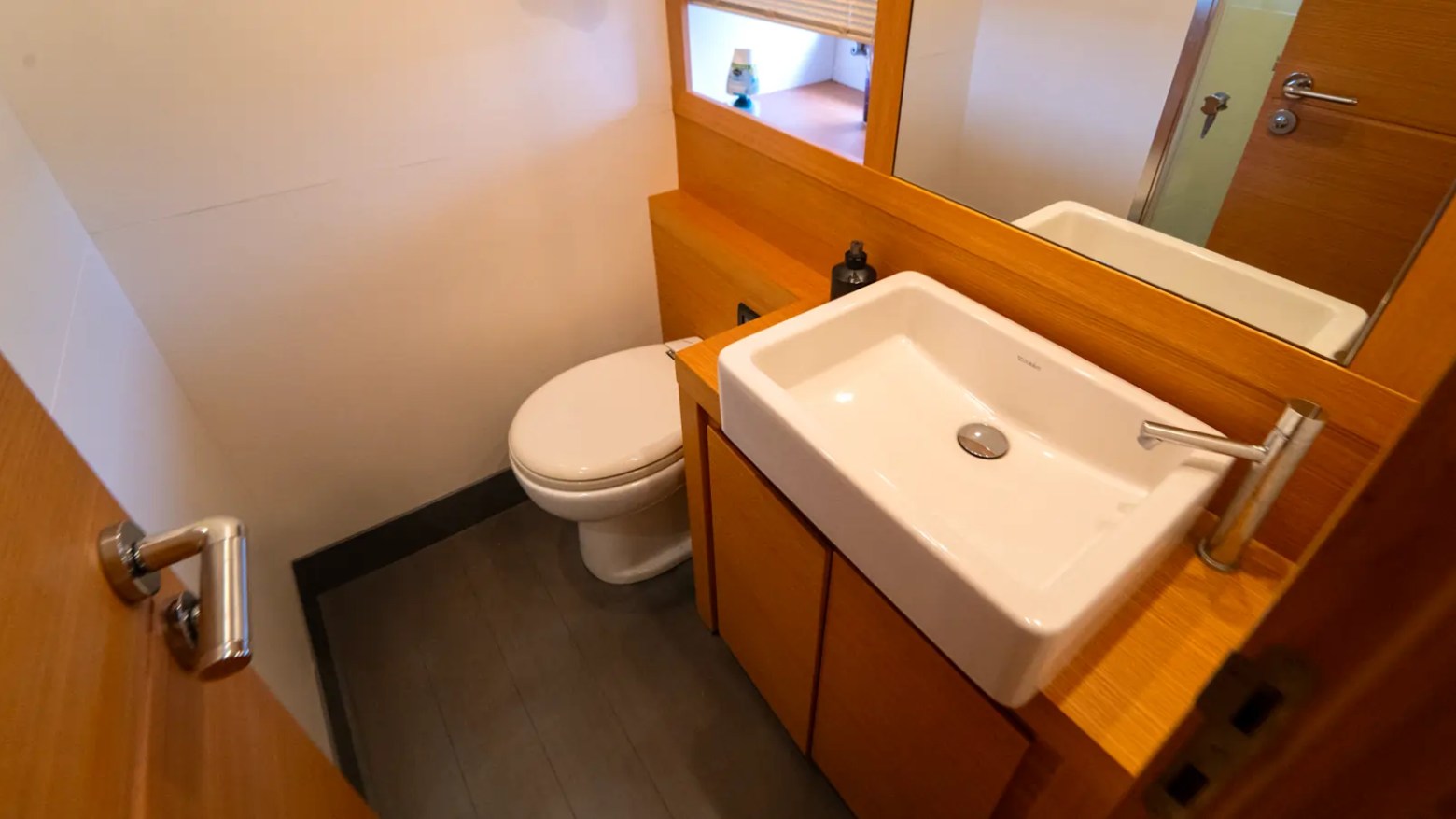 64' Pershing Yacht Charter guest day head with modern vanity, premium sink, and contemporary bathroom amenities aboard a luxury yacht in Miami.