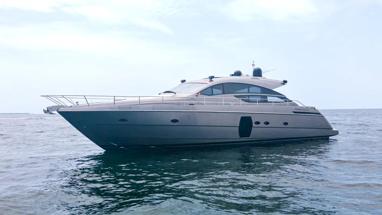 64' Pershing Yacht Charter showcasing its sleek Italian performance profile while cruising the open waters of Biscayne Bay near Miami.
