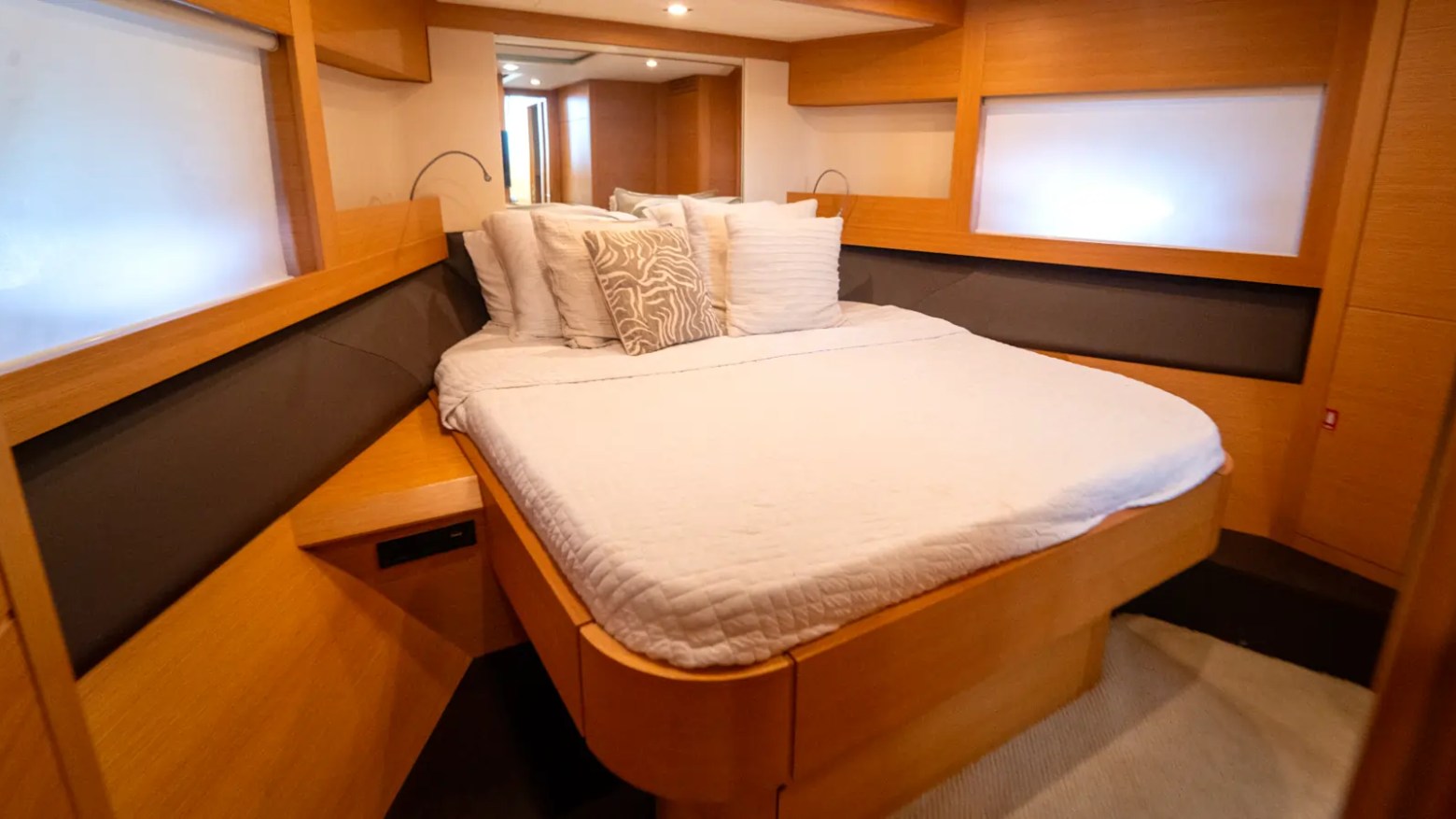 64' Pershing Yacht Charter VIP stateroom with queen berth, modern wood finishes, and luxury overnight accommodations in Miami aboard a premium yacht.