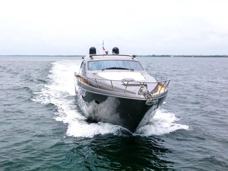 64' Pershing Yacht Charter powering across the Atlantic Ocean off Miami Beach, showcasing its sleek Italian profile, performance hull, and exhilarating luxury cruising experience.