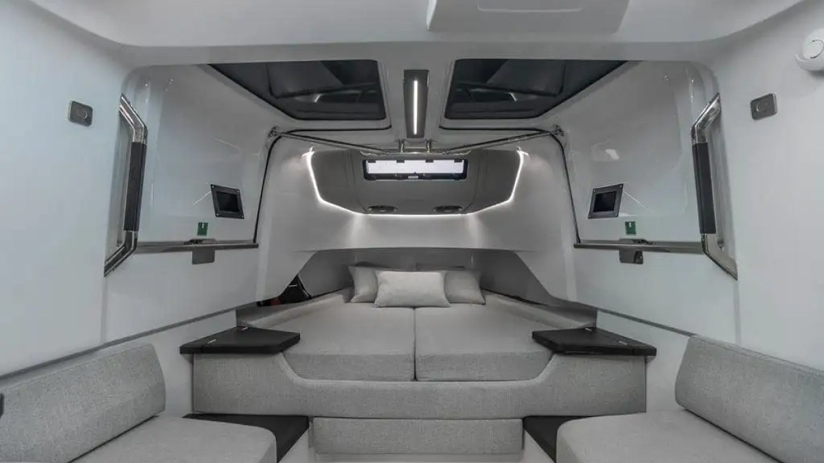 This 38 foot Axopar Boat Rental features a modern forward cabin lounge with convertible sleeping area, skylights, and minimalist Scandinavian styling near North Bay Village and Biscayne Bay in Miami.