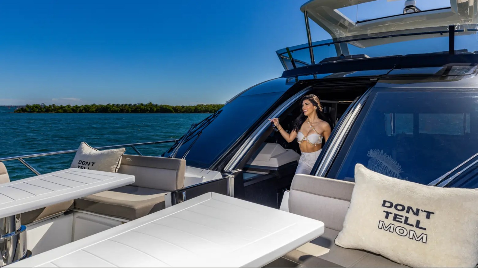 68' Galeon Yacht Charter featuring the elevated bow lounge with convertible tables skylounge access and panoramic Biscayne Bay views while anchored near Key Biscayne.