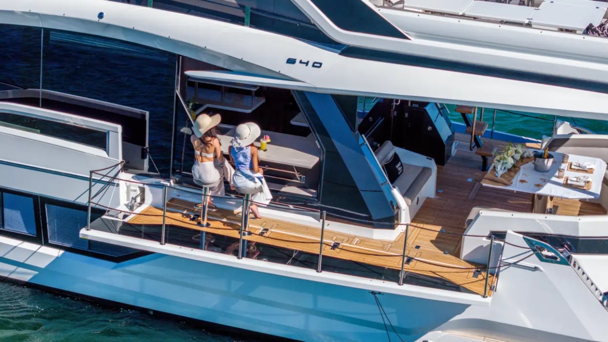 68' Galeon Yacht Charter highlighting the foldout beach club terrace with bar seating and open cockpit lounge while cruising near Key Biscayne on Biscayne Bay.