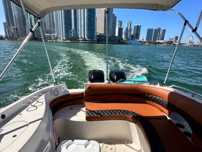 Aft seating aboard a 30' Hurricane Boat Rental cruising past the Miami skyline on Biscayne Bay.