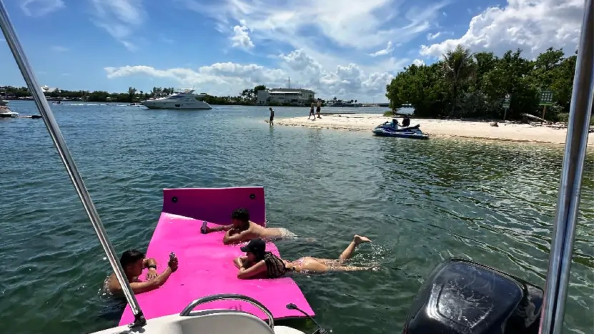 30' Hurricane Boat Rental with a Magic Carpet floating mat anchored at Monument Island in Miami.