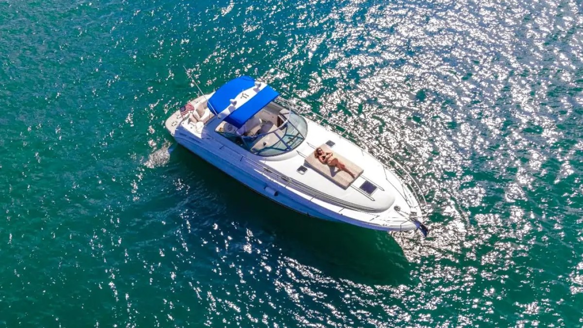 45' SeaRay Boat Rental aerial drone view cruising Miami waters with bow sun pad.