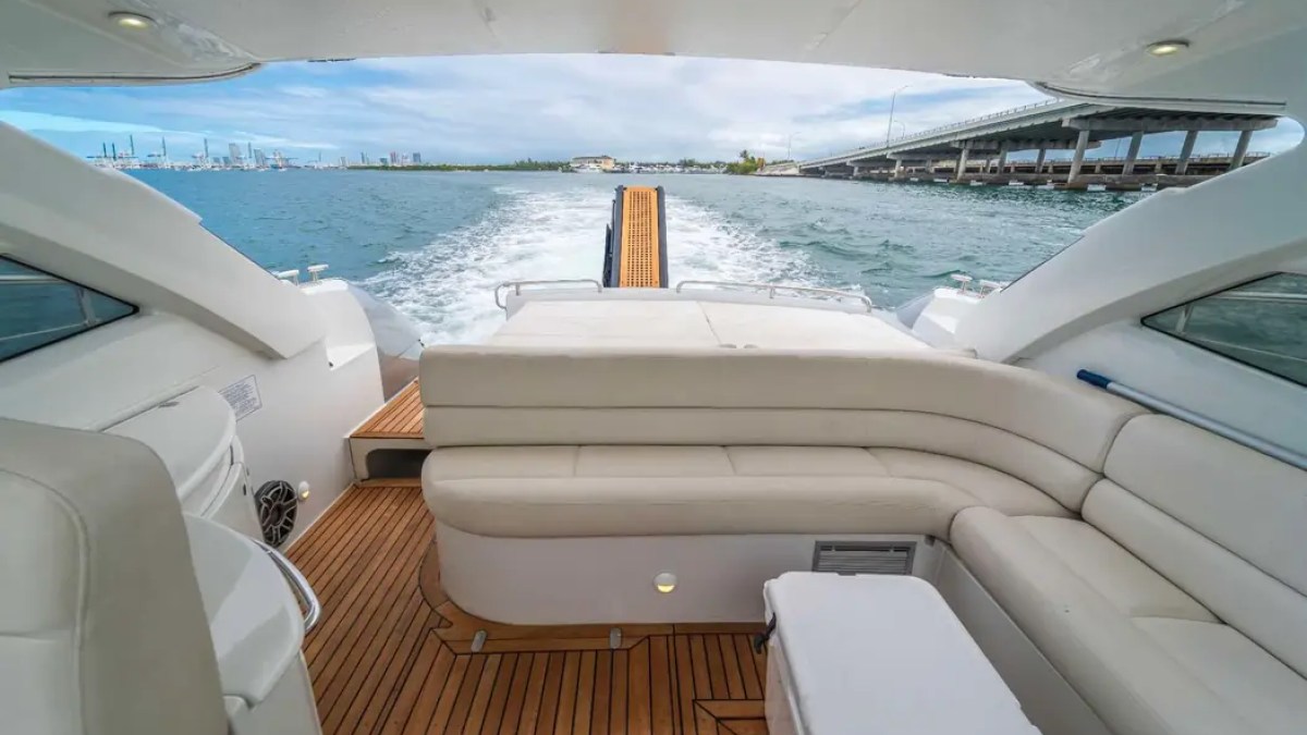 50' Pershing Yacht Charter aft cockpit with spacious lounge seating and Miami waterfront views during a private cruise.