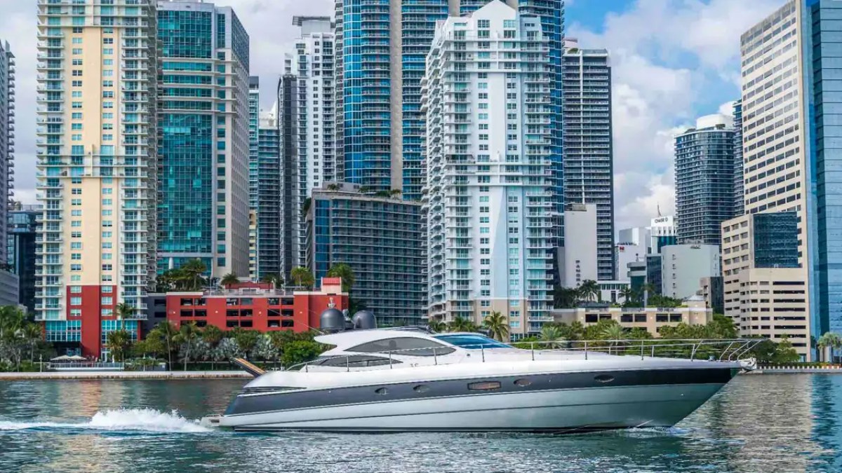 50' Pershing Yacht Charter cruising along the Miami River with the Brickell skyline during a luxury private yacht experience.