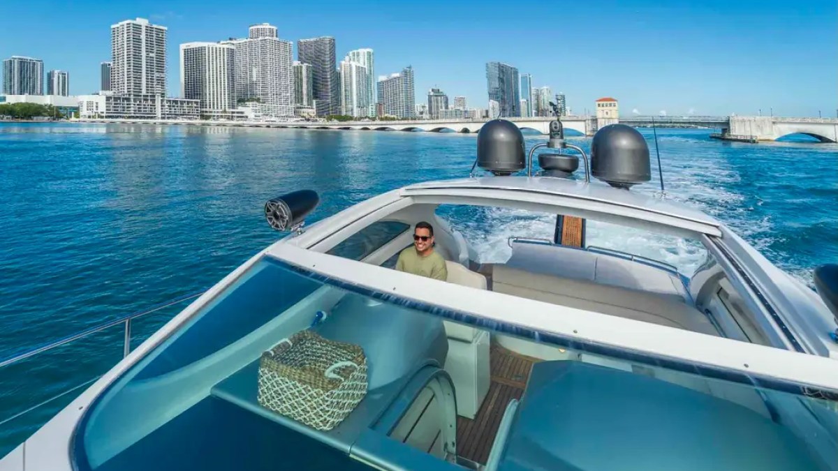 50' Pershing Yacht Charter helm station with panoramic Miami skyline views during a luxury private cruise.