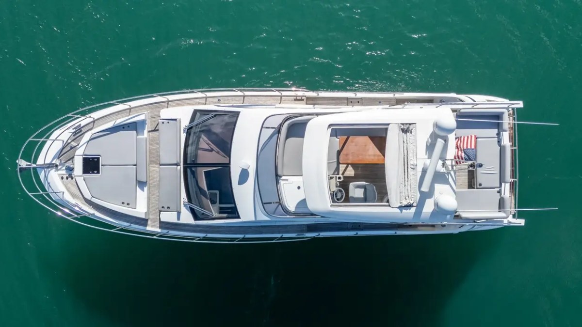 Aerial view of a 52' Azimut Yacht Charter showcasing the full deck layout while anchored in Miami waters.
