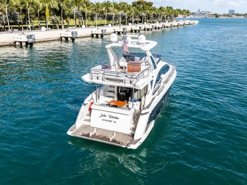 52' Azimut Yacht Charter aerial stern view cruising Miami waters near Museum Park.