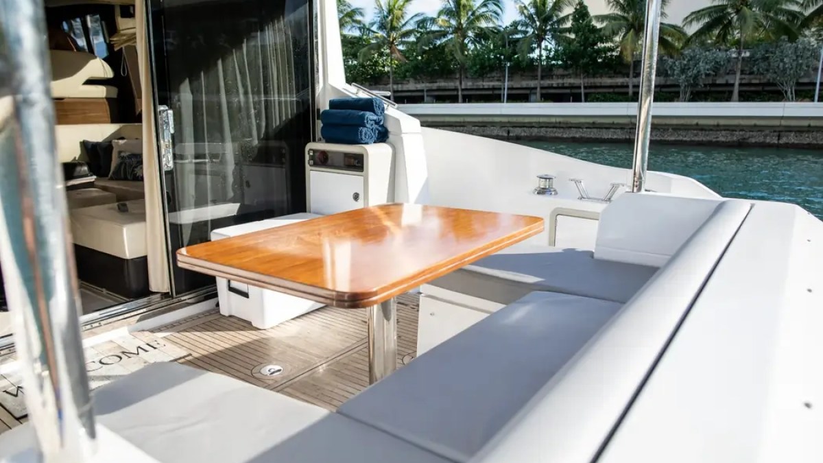 52' Azimut Yacht Charter aft cockpit dining area with shaded outdoor seating in Miami.