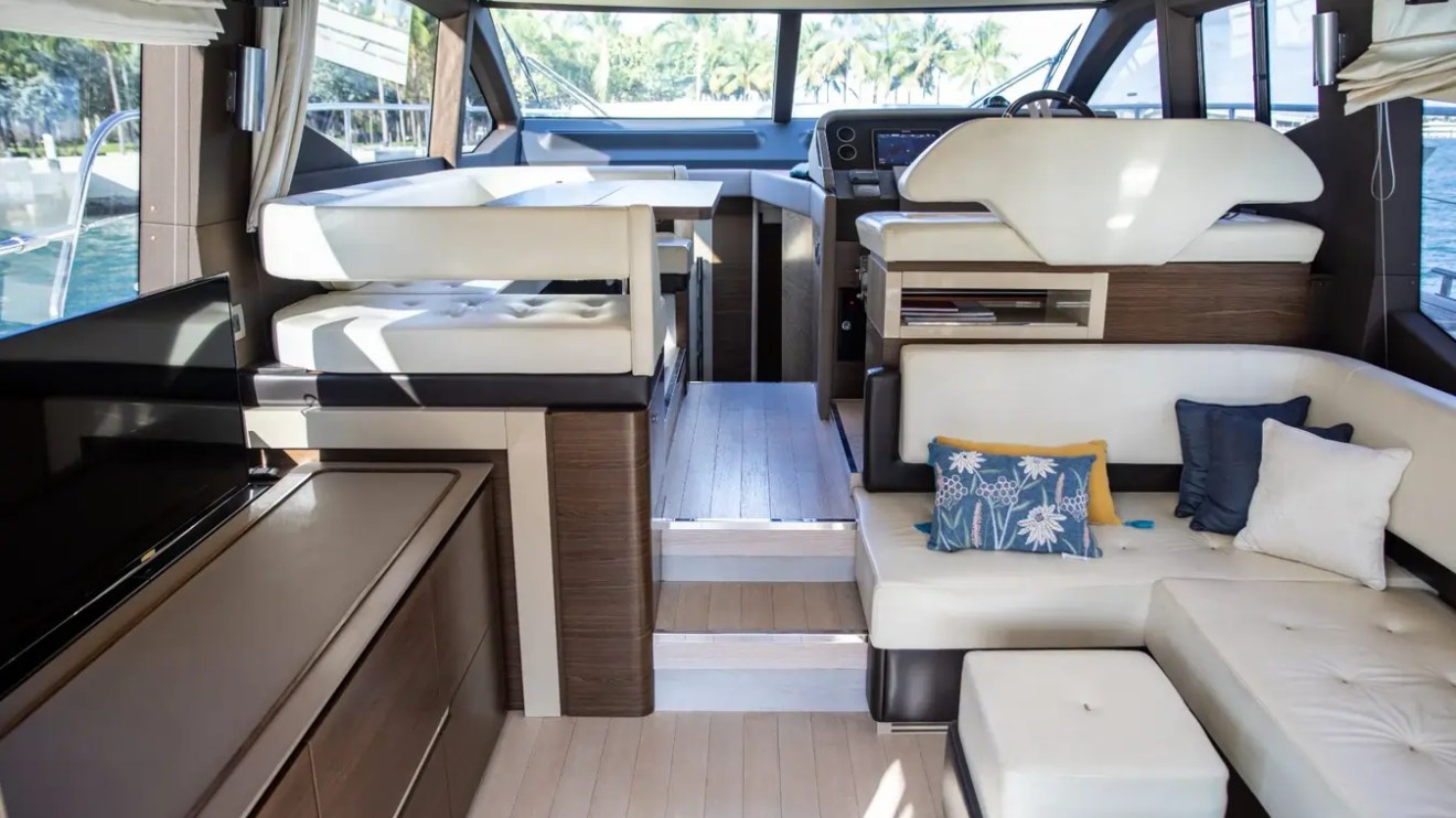 Main salon aboard a 52' Azimut Yacht Charter featuring panoramic windows, luxury seating and an open helm in Miami.