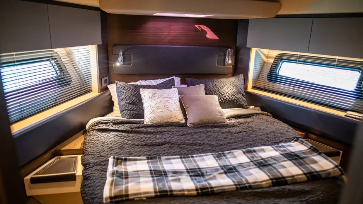 Master stateroom aboard a 52' Azimut Yacht Charter featuring a queen berth and elegant accommodations in Miami.