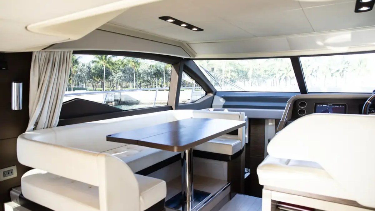 Salon dining area aboard a 52' Azimut Yacht Charter featuring panoramic windows and elegant seating in Miami.
