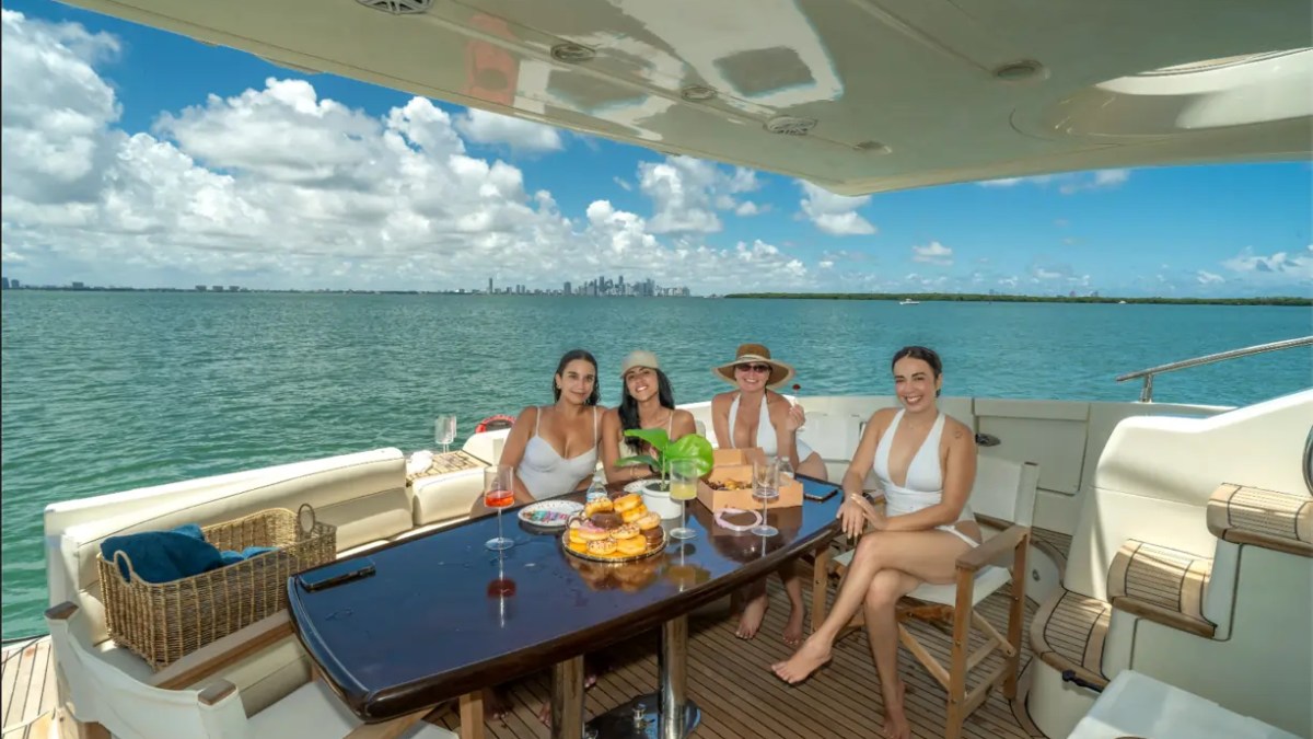 65' Azimut Yacht Charter aft deck dining experience with Biscayne Bay views in Miami.