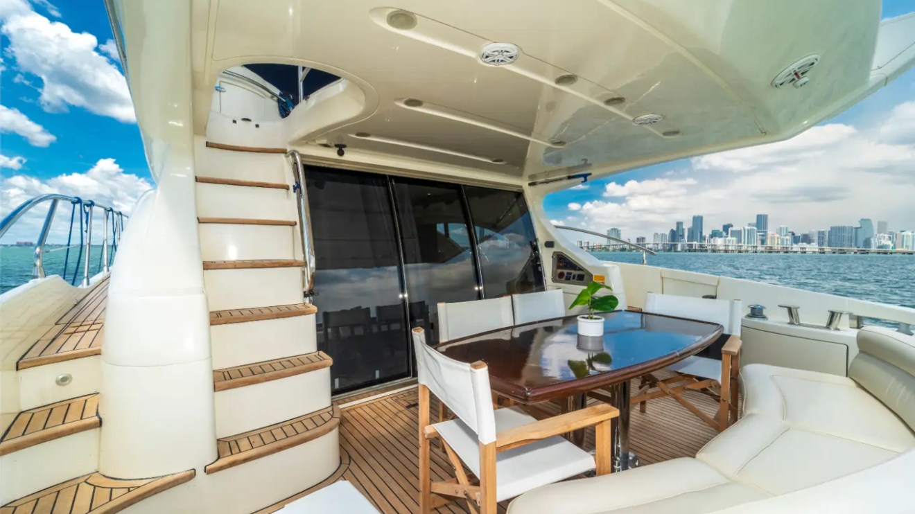 65' Azimut Yacht Charter aft deck lounge and outdoor dining area in Miami.