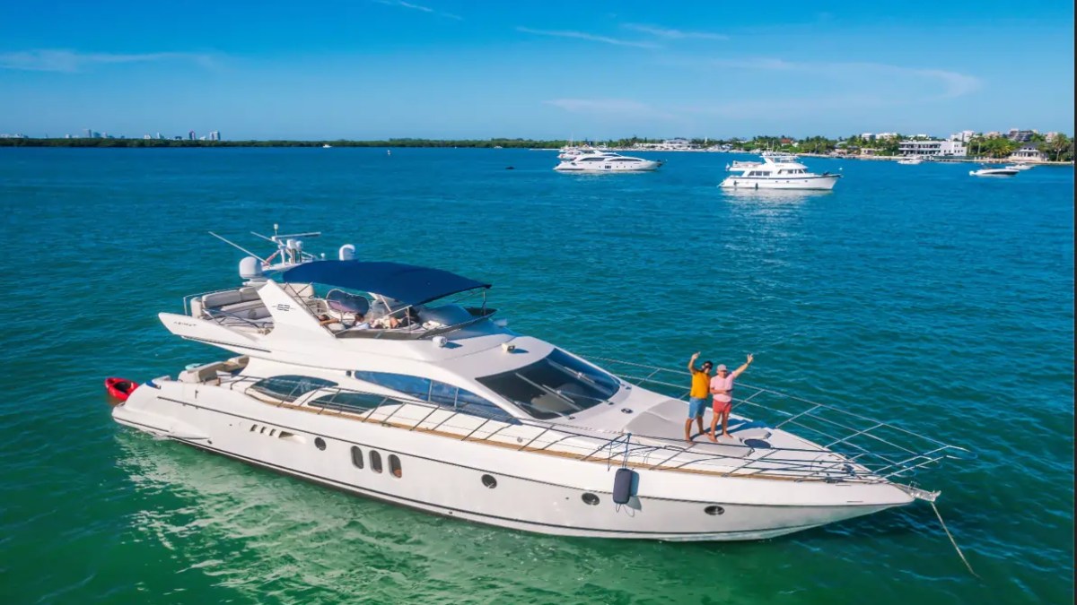 65' Azimut Yacht Charter anchored on Biscayne Bay in Miami with guests enjoying the bow.