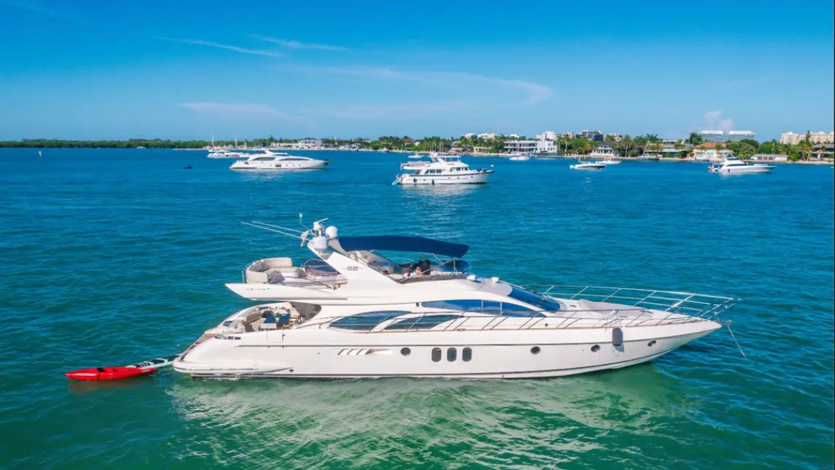 65' Azimut Yacht Charter cruising on Biscayne Bay in Miami with kayak and luxury flybridge.