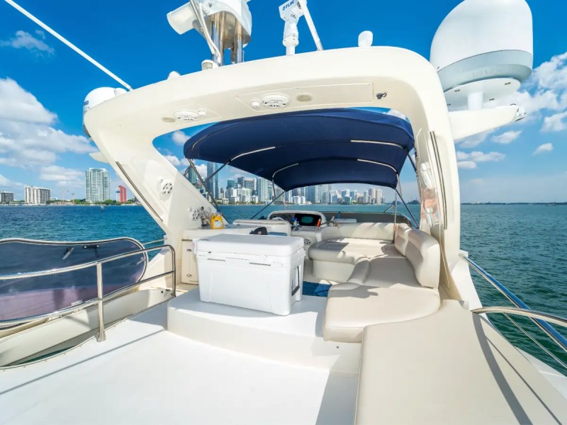 65' Azimut Yacht Charter flybridge with upper helm and lounge seating in Miami.