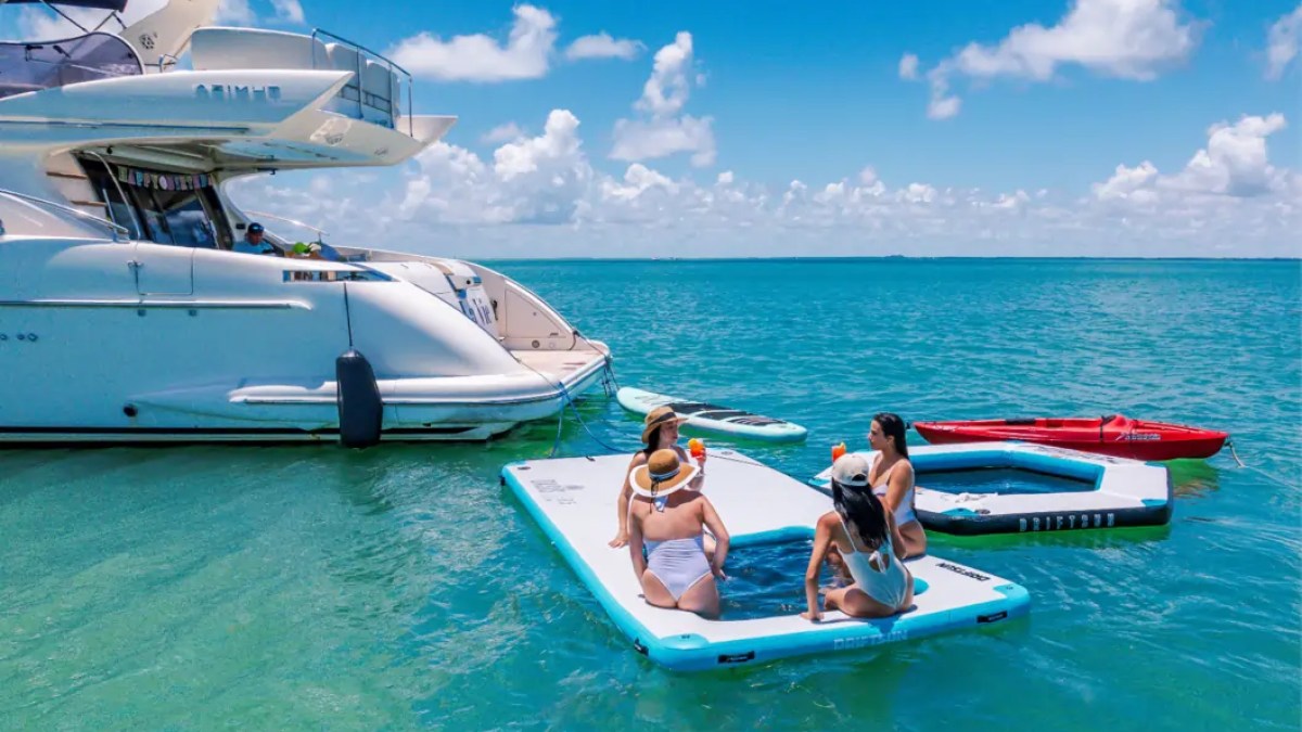 65' Azimut Yacht Charter guests enjoying the Magic Carpet, kayak & paddleboard on Biscayne Bay in Miami.