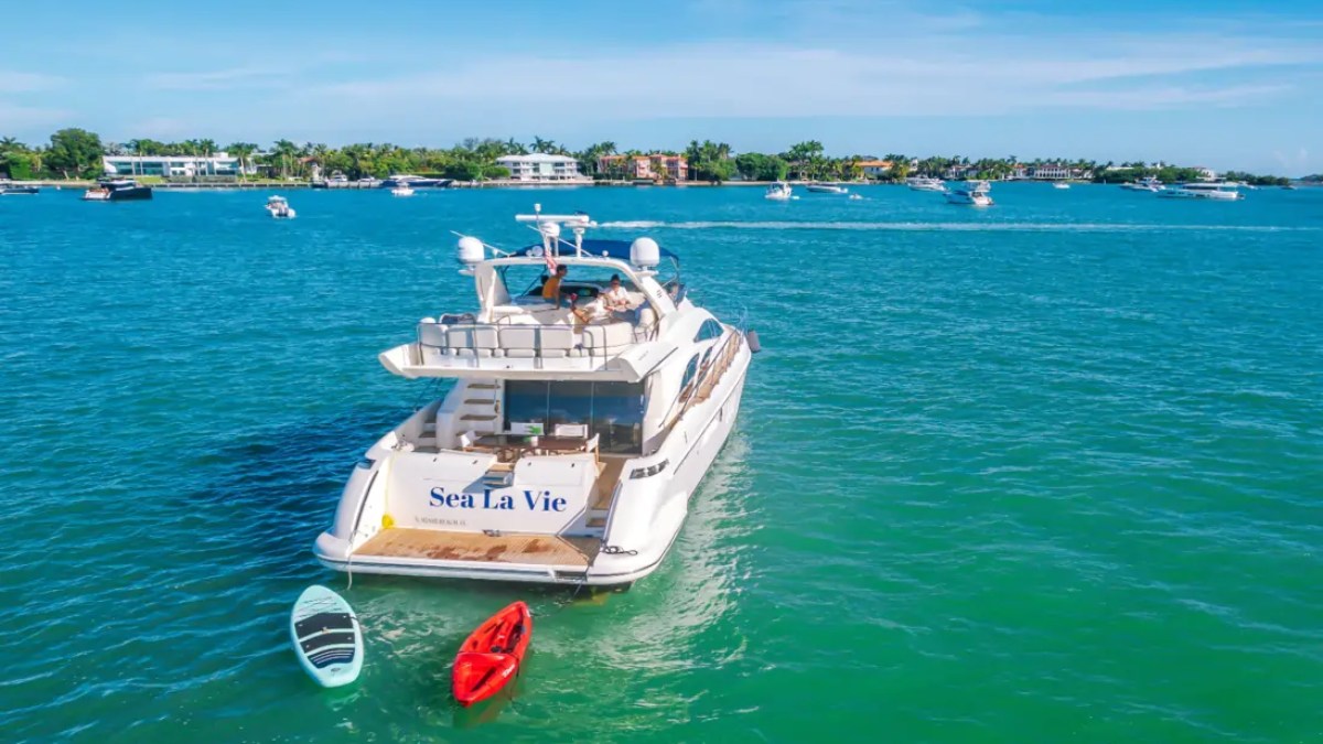 65' Azimut Yacht Charter anchored on Biscayne Bay in Miami with paddleboard & kayak.