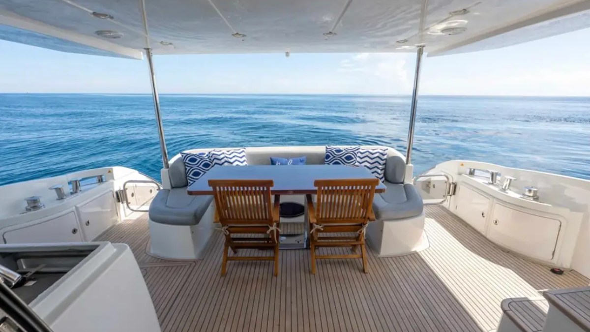 70' Azimut Yacht Charter aft deck dining area with wraparound seating and panoramic ocean views in Miami.