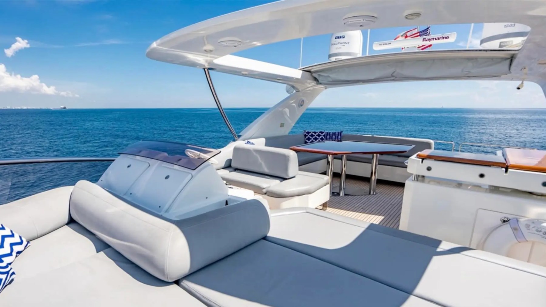 70' Azimut Yacht Charter flybridge lounge with helm, wet bar and panoramic ocean views in Miami.