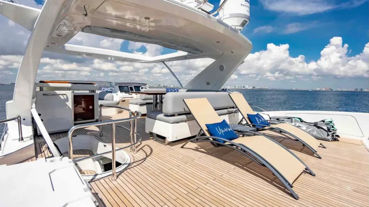 70' Azimut Yacht Charter flybridge featuring oversized sun loungers, wet bar and panoramic Biscayne Bay views in Miami.