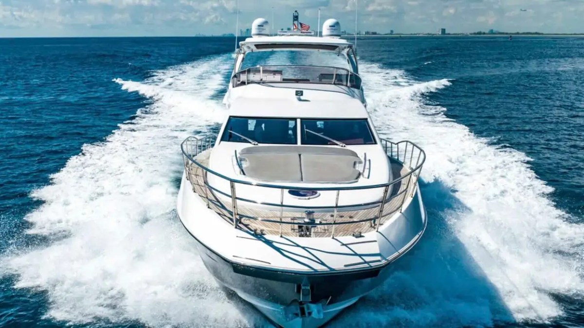70' Azimut Yacht Charter powering across Miami waters with luxury flybridge and spacious foredeck.