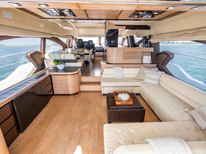70' Azimut Yacht Charter luxury salon with panoramic windows, plush seating and open-concept interior in Miami.