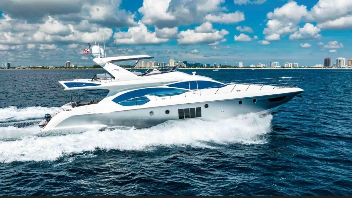 70' Azimut Yacht Charter side profile cruising through Miami with luxury flybridge and elegant Italian styling.