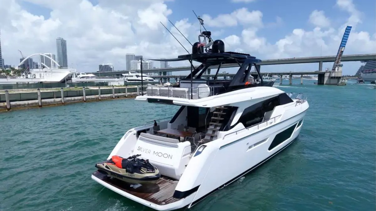 80' Ferretti Yacht Charter aft view with hydraulic swim platform and personal watercraft cruising in Miami.