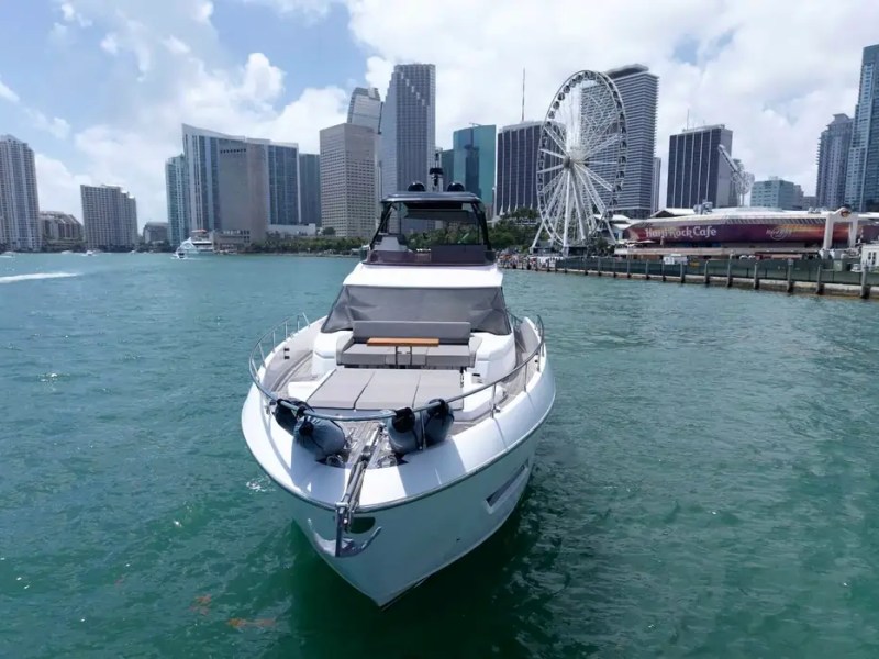 80' Ferretti Yacht Charter bow view with Downtown Miami skyline on Biscayne Bay.