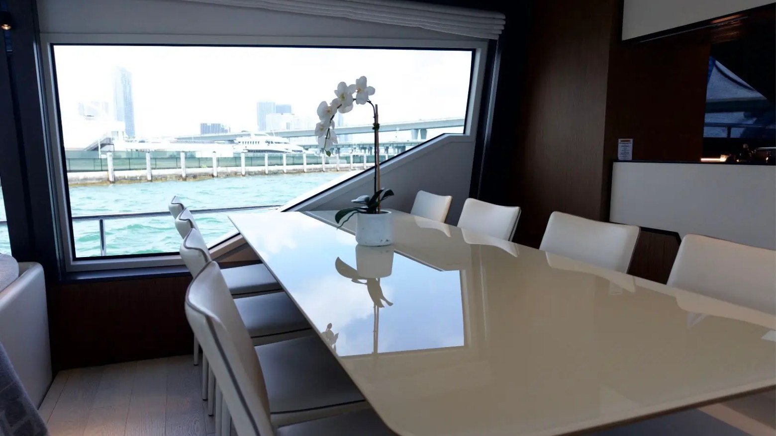 80' Ferretti Yacht Charter formal dining area with panoramic waterfront views in Miami.