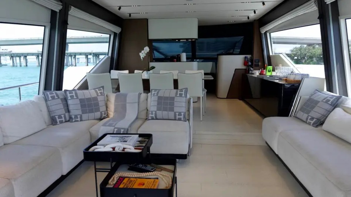 80' Ferretti Yacht Charter luxury salon with panoramic windows and formal dining area in Miami.