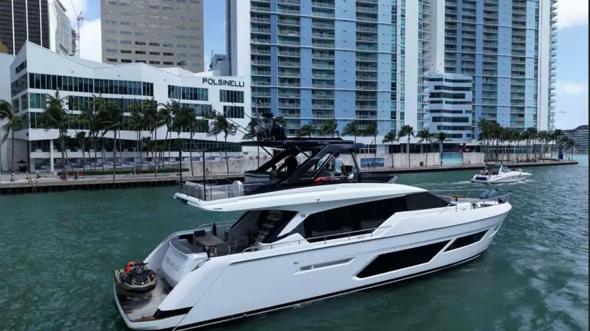 80' Ferretti Yacht Charter docked on the Miami River with personal watercraft and flybridge.