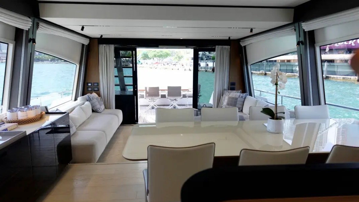 80' Ferretti Yacht Charter open-concept salon and dining area with panoramic waterfront views in Miami.