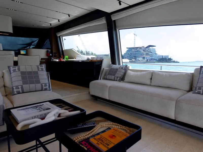 80' Ferretti Yacht Charter elegant salon with panoramic windows and luxury lounge seating in Miami.