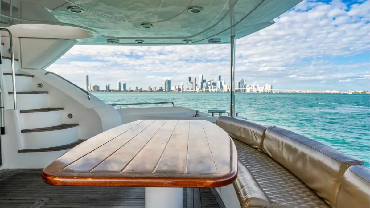 90' Azimut Yacht Charter aft deck dining with waterfront skyline views in Miami.